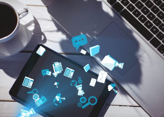 digital composite of smart devices with coffee on table with graphics